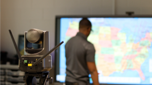 Clear Touch Redefines Mobile Broadcasting with the Official Launch of Command Studio 15 A Clear Touch Command Studio wireless PTZ camera mounted on a tripod, featuring dual antennas and 20x optical zoom for professional mobile broadcasting in a classroom or office setting.