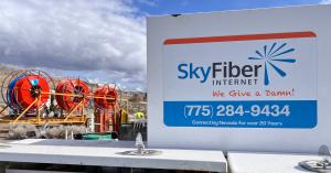 Sky Fiber Internet equipment in rural Nevada with fiber reels and branded service truck