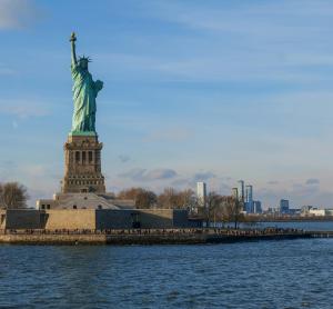Statue of Liberty standing tall in New York Harbor, symbolizing freedom and global welcome