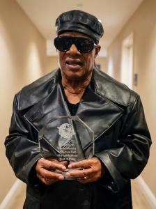 Legendary Stevie Wonder holding his induction award from the R&B Hall of Fame