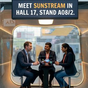 Sunstream Global Technologies LLP, a trusted partner in high-value engineering services, is proud to announce its participation in Hannover Messe 2026, the world’s leading industrial technology trade fair Three professionals in business attire sit around a high table in a modern, glass-walled meeting pod at a trade show. A digital sign above them reads
