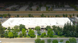 Life-Assist, the nation’s leading employee-owned distributor of emergency medical equipment and supplies for First Responders, today announced the expansion of its Northern California headquarters Aerial view of the Life-Assist headquarters building in Rancho Cordova, California, showing a large warehouse facility with surrounding parking, trees, and nearby canal.