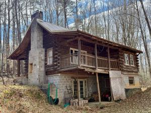 2 BR/1 BA log home w/walk-out basement on 5.01 +/- acres in Spotsylvania County, VA -- Detached 3 bay garage -- Ideal for a rehab project or a well located 5 acre lot for your dream home!! -- Centrally located only 2 miles from Rt. 3, 5.5 miles from I-95
