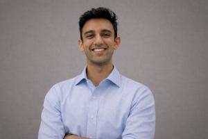 Raza Rauf, full-stack AI engineer at 316 Strategy Group, in a blue shirt against a gray background, professional headshot.