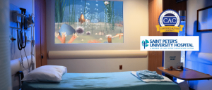 Hospital room with a bed, medical equipment, a calming underwater-themed projector, and Saint Peter's University Hospital branding.