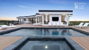 Custom Island Homes Contemporary Outdoor Living Space with Integrated Pool and Lounge Deck