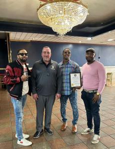 Antonio Bond and Rodney Dennis, co-owners of Wave Bar & Lounge, stand with Canton city leadership during the restaurant’s grand opening event in Canton, Ohio.