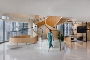 spiral steps in terrazzo with built in bench, sculptural base steps with views of the city