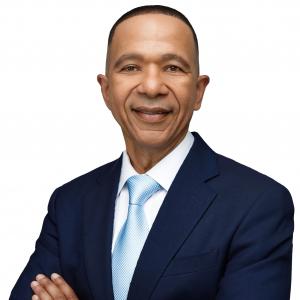 Professional headshot of Dr. Jude Jeanville in a navy suit and blue tie, author of Women and the Church: What the Bible Actually Says