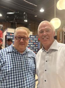 Sir Michael Fomkin, Co-Founder of VIP Ignite, and Pastor Bruce Deel of City of Refuge pose together at the Atlanta premiere of The Greatest of These on April 16, 2026, with the film's branded step-and-repeat banner displaying the Greatest of These, Abunda