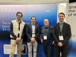 ChargeHub, AXSO, and Circuit électrique representatives at the AXSO booth during an EV charging industry event.