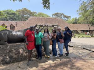 Group of people infront of the Nairobi National park gate.