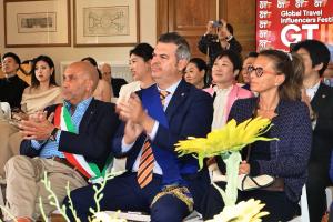 Public Officials and international guests attending discussions during the Global Travel Influencers Festival in Italy.