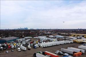 A Birdstop drone is seen flying above a lot used freight truck parking monitoring for available space.