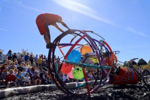 Kinetic Sculpture pilot is rotating Big Ball's frame to get through the mud pit