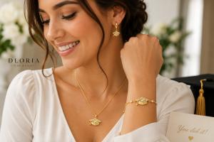Woman wearing graduation jewelry set with necklace earrings and bracelet by Dloria Fine Jewelry in lifestyle setting