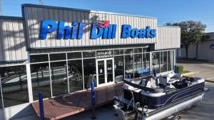 Marine Dealer Tools Boat in Front of Phil Dill Boats