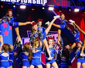 A major new opportunity for athletes across the North of England and Scotland is arriving this summer as Cheer Athletics Carlisle officially launches in June 2026 Young athletes perform advanced stunts during a competition routine, representing the launch of Cheer Athletics Carlisle and new opportunities for cheerleaders in Northern England.