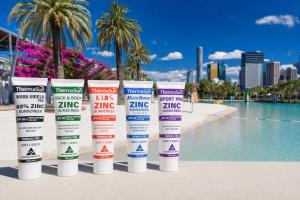 As regulators around the world reassess chemical UV filters, ThermaSun is launching with a direct challenge to the sunscreen industry: if zinc oxide is the future of sun protection, it has to become affordable enough for everyone 5 Tubes of sunscreen posed in front of South Bank public beach, Brisbane, Australia.