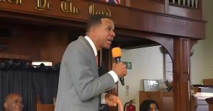 Dr. Jude Jeanville addressing an audience during a ministry and public speaking event focused on faith and theology