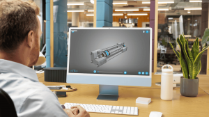 A professional engineer viewing a 3D model of an industrial pneumatic cylinder on a desktop computer in a modern workspace with plants and office equipment.