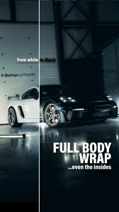 Before and after full body wrap on a Porsche sports car by 2wrap.com, left side in original white, right side in gloss black wrap including interior panels, photographed in the 2wrap workshop
