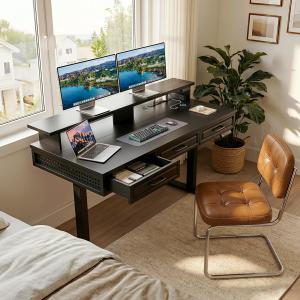 Compact black standing desk with hidden storage drawers, dual monitors, and monitor riser in a minimalist bedroom office setup.