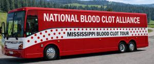 A large polka dot Blood Clot Awareness Bus from the National Blood Clot Alliance parked outdoors during the 2026 Mississippi Blood Clot Awareness Bus Tour.