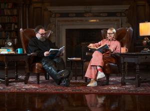 Author Emma Straub and host Chris Collins sit opposite one another, reading Miss Piggy's Guide to Life and laughing.