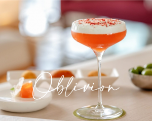 Sip the spirit of Italian summer. The Oblivion cocktail, served at a panoramic cliffside bar with sunset views over the Gulf of Naples.
