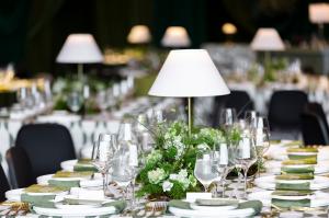 Low mossy centerpiece with white blooms, ferns, and delicate grasses creates a clean, natural aesthetic at the Thaden School gala. Photo by Kaity Whitman, Rose of Sharon Floral Design Studio.