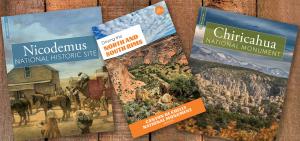 Three national park books on wood background