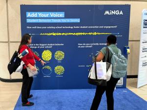 People standing at an engagement wall filled with yellow stickers