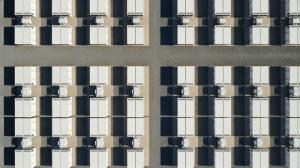 Top-down aerial rendering of a utility-scale Prevalon HD5™ AC battery energy storage installation featuring multiple rows of integrated battery enclosures and power conversion systems arranged in a symmetrical high-density layout with access roads between