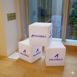 Finjobsly corporate branding logo cubes on display at the company headquarters for an official press announcement.