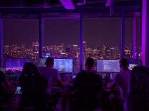 Qtonic Quantum Corp Launches QScout Pulse for 24/7/365 Quantum Risk and Vulnerability Intelligence 11 QScout Pulse overnight cybersecurity operations team monitoring live quantum risk and vulnerability intelligence dashboards at night.