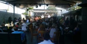 Crowd watching a live performance at the outdoor stage of Rockefellas Bar in Corona California.
