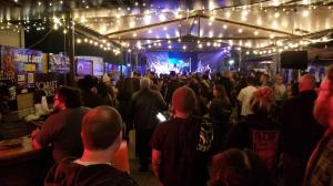 Outdoor patio performance area at Rockefellas Bar with band stage and audience seating.