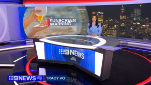 Nine News Reporter, Tracy Vo, commencing report on "Are there dangerous chemicals in your child's sunscreen?" with an image of someone applying sunscreen over their hands taken on a beach with the words superimposed "Sunscreen Warning"