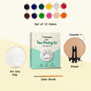 DIY paw printing kit showing air-dry clay, paint colors, brush, coaster, stand, and pet paw impression materials.