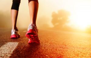 photo man with red running shoes on walking in a bare desert area all in gold colors