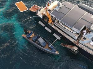 Swedish performance boat manufacturer IRON Boats is gaining increased attention in the luxury yacht tender sector through its patented Iron Fender system, a design approach intended to combine elements of rigid inflatable boats (RIBs) with traditional hard-hull performance boats Ariel photo of sailing yacht on anchor with an IRON tender tied up with it