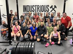 Members and head coach, Danny Tran, at Industrious Puyallup gather following a workout. The gym has become known for its community-focused approach to fitness, recovery, and long-term wellness throughout Pierce County.
