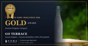 Promotional key visual announcing TSUNAN SAKE BREWERY's GO TERRACE Junmai Daiginjo winning Gold at the Tokyo Sake Challenge 2026, with a gold award medal and the GO TERRACE bottle on a navy background.