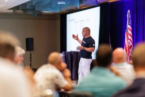 Man speaking in front of audience at conference