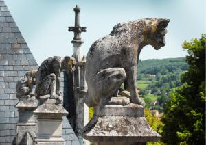 gargoyles and chimeres protecting a French chateau with countryside views in the distance