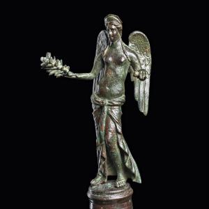 Eastern Mediterranean early Imperial period (circa 1st-2nd century CE) cast-bronze statuette depicting the winged goddess Victory (or Nike), arms outstretched holding a laurel wreath. Estimate: $56,000-$84,000