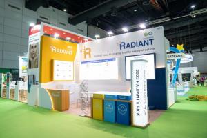 RADIANT by ecoplantly exhibition booth at in-cosmetic Asia displaying 2023 product picks including Bee Fence, Prediome, and Basilgel Water with modern yellow, white, and blue color scheme