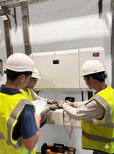 Solaren engineers inspecting premium solar equipment, electrical meters, monitoring devices, and clean energy system components for a commercial solar installation in the Philippines.