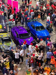 Visitors gather around a display of modified and performance vehicles during GSF Car Parts TechFest North at Newcastle's Utilita Arena.